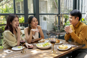 Three asian people having food together.